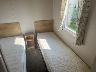 https://thefamilyparksgroup.co.uk/wp-content/uploads/2023/09/Twin-bed.jpg